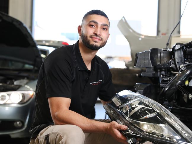 Radwan Dandan is balancing his job at a smash repairs business with online learning. Picture: Richard Dobson