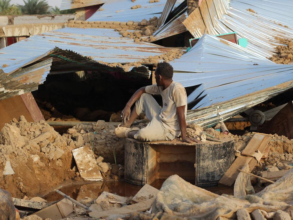 A Sudanese man sits amid the destruction in his village near the northern Sudanese town of Dongola. Picture: AFP