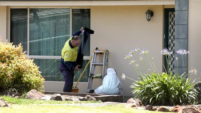 Cleaners at the house on Monday afternoon. Picture: Dean Martin