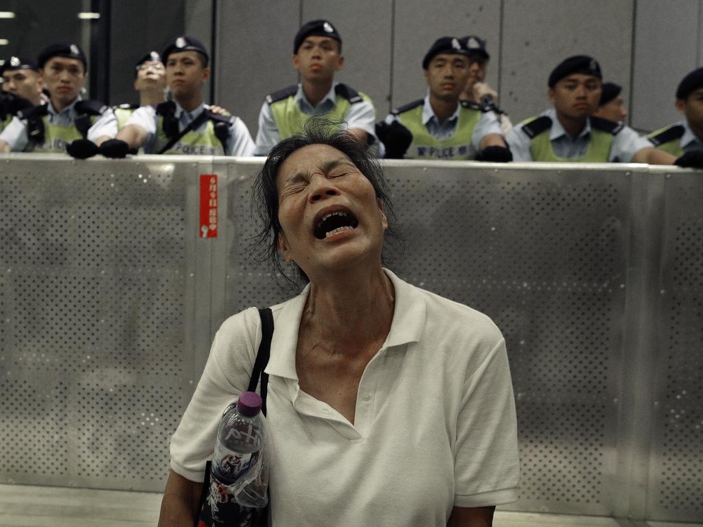 A protester reacts as police officers clash with protesters. Picture: Vincent Yu/AP