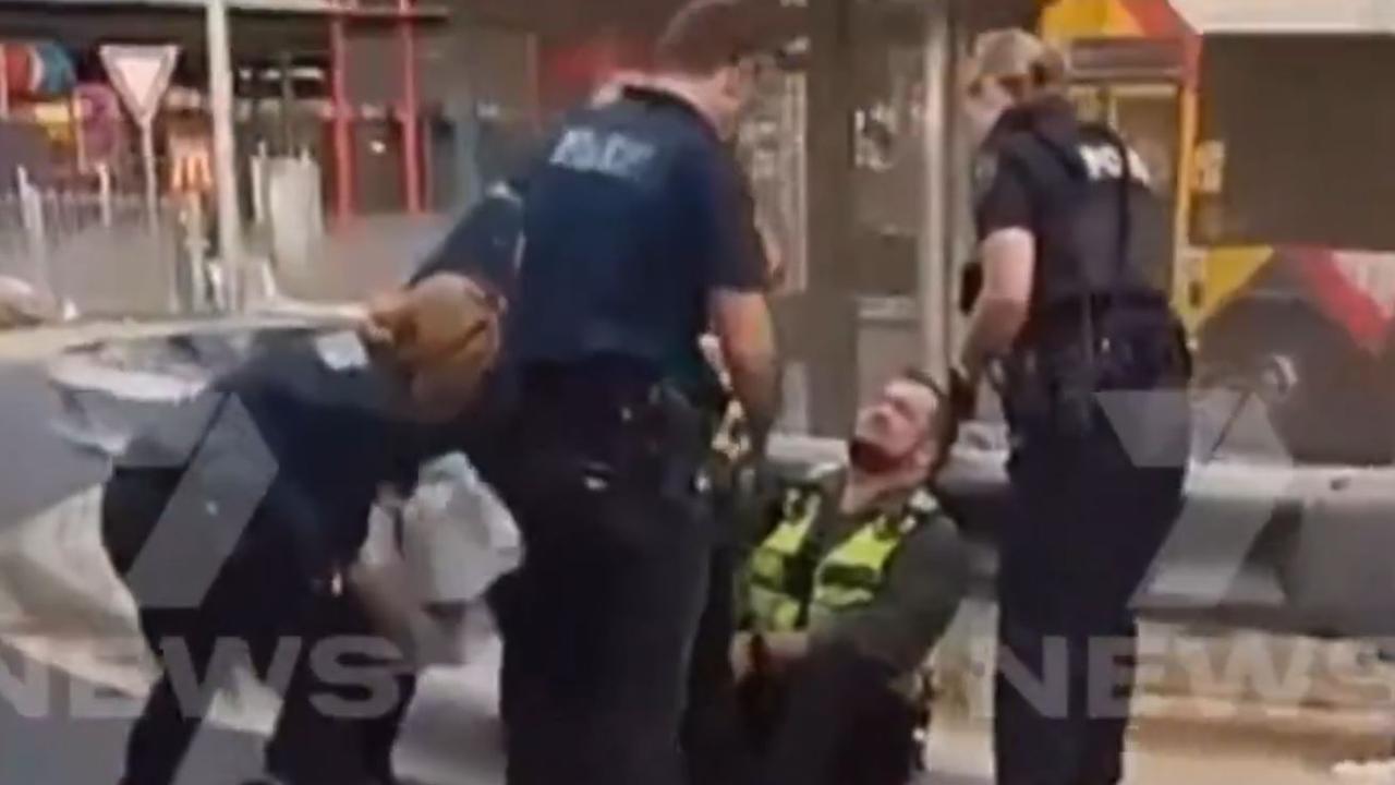 Police with the stabbed security guard. Picture: 7NEWS