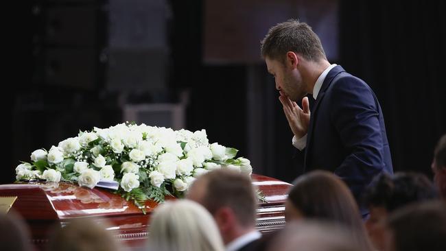 MACKSVILLE, AUSTRALIA - DECEMBER 03: Australian cricket captain Michael Clarke pays his respect to Phillip Hughes during the Funeral Service for Phillip Hughes on December 3, 2014 in Macksville, Australia. Australian cricketer Phillip Hughes passed away last Thursday, aged 25, as a result of head injuries sustained during the Sheffield Shield match between South Australia and New South Wales at the SCG on Tuesday 25th November. (Photo by Cameron Spencer - Pool/Getty Images)