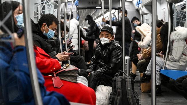 People wear face masks on a train amid the Covid-19 pandemic in Beijing. Picture: AFP