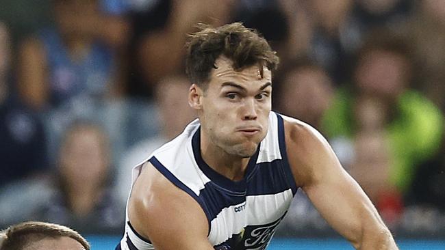 MELBOURNE, AUSTRALIA - MARCH 23: Jack Bowes of the Cats handballs whilst being tackled by Patrick Cripps of the Blues during the round two AFL match between Carlton Blues and Geelong Cats at Melbourne Cricket Ground, on March 23, 2023, in Melbourne, Australia. (Photo by Daniel Pockett/Getty Images)