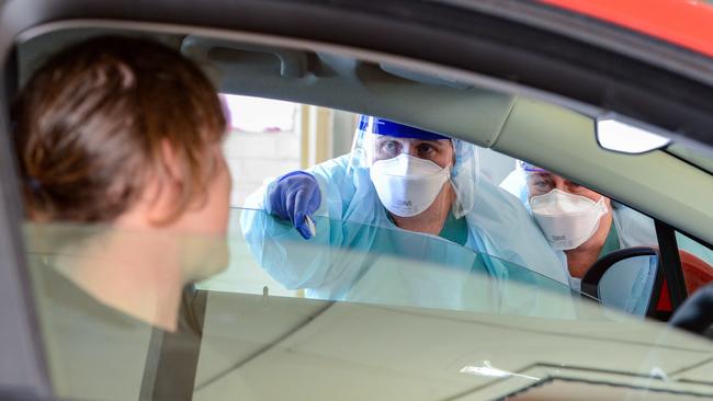 Nurses speak to the first patient to use the new drive-through coronavirus test station. Picture: AAP / Brenton Edwards