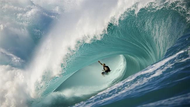 Want to take a photograph like this? Gold Coast photography maestro Ted Grambeau will show you how. Australian surfer Mark Matthews puts on a show at Teahupoo, Tahiti. Picture: Ted Grambeau Photography. @tedgrambeau 