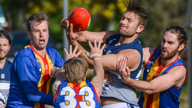 Henley’s Jack Enright handballs under pressure during the Sharks’ match against Old Ignatians in 2020. Picture: Brenton Edwards