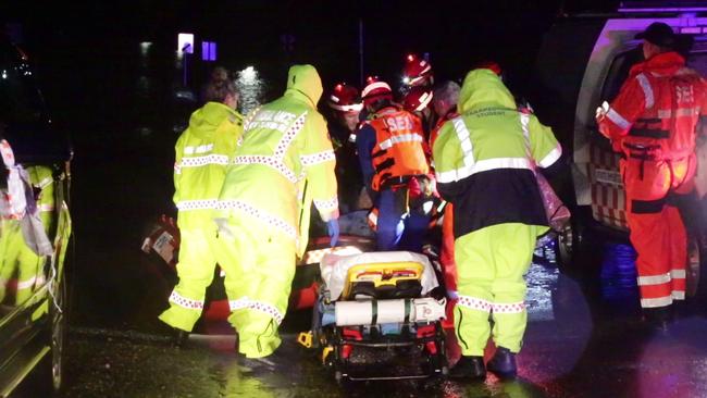 Colleagues rush an SES worker bitten by a snake to hospital. Picture: TNV