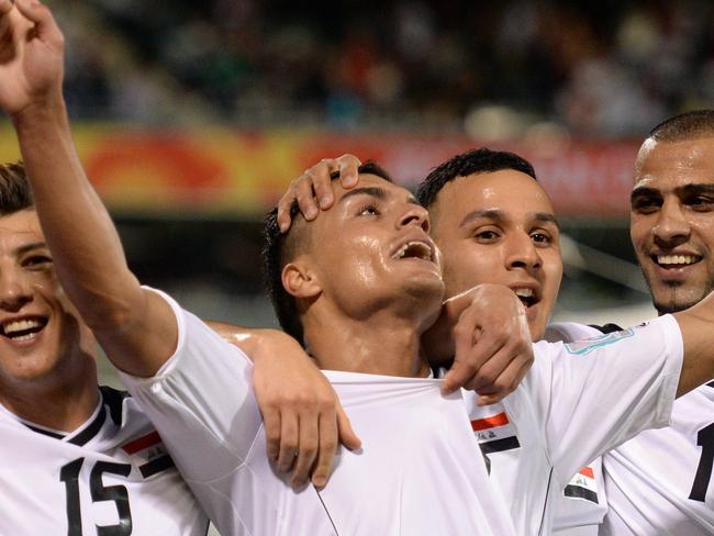 Ahmed Yaseen Gheni of Iraq (C) celebrates scoring against Palestine with teammates Waleed Salim Al­-Lami (L) Dhurgham Ismael Dawood (2nd-R) and Marwan Hussein Al-­Ajeeli (R) during their Group D football match of the AFC Asian Cup in Canberra on January 20, 2015. AFP PHOTO/Peter PARKS --IMAGE RESTRICTED TO EDITORIAL USE - STRICTLY NO COMMERCIAL USE