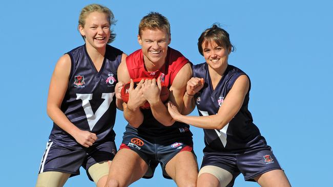 Sylvia hams it up with then-Victorian Women footballers Phoebe McWilliams and Daisy Pearce at the Womens National League launch in 2011.