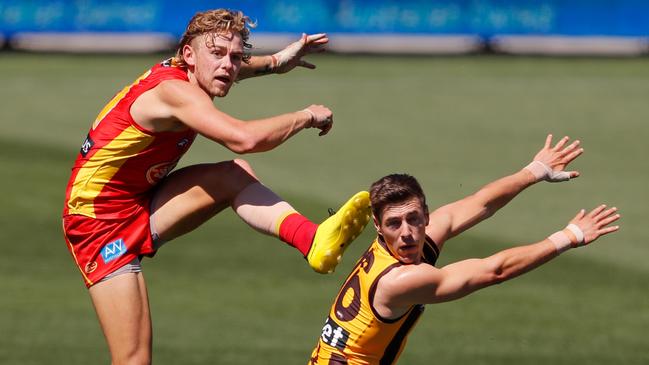 Hugh Greenwood of the Suns kicks the ball past James Cousins of the Hawks during the 2020 AFL Round 18 match between the Hawthorn Hawks and the Gold Coast Suns at Adelaide Oval on September 20, 2020 in Adelaide, Australia. (Photo by Matt Turner/AFL Photos via Getty Images)