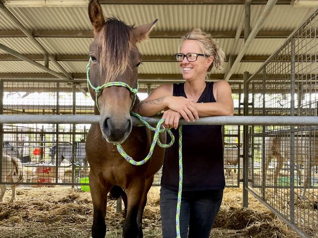 Ainslie Daniels with 'Mr Brown', one of the 13 horses she evacuated to Castle Hills Showground after floods hit South Windsor in early March 2022. Picture: Odessa Blain.