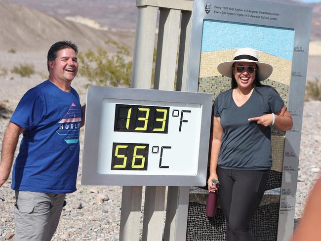 Clint Johnson, of Pleasant Hill, California, and Melanie Anguay, of Las Vegas, pose next to the heat reading at Furnace Creek Visitor Centre in Death Valley National Park. Picture: Ronda Churchill / AFP