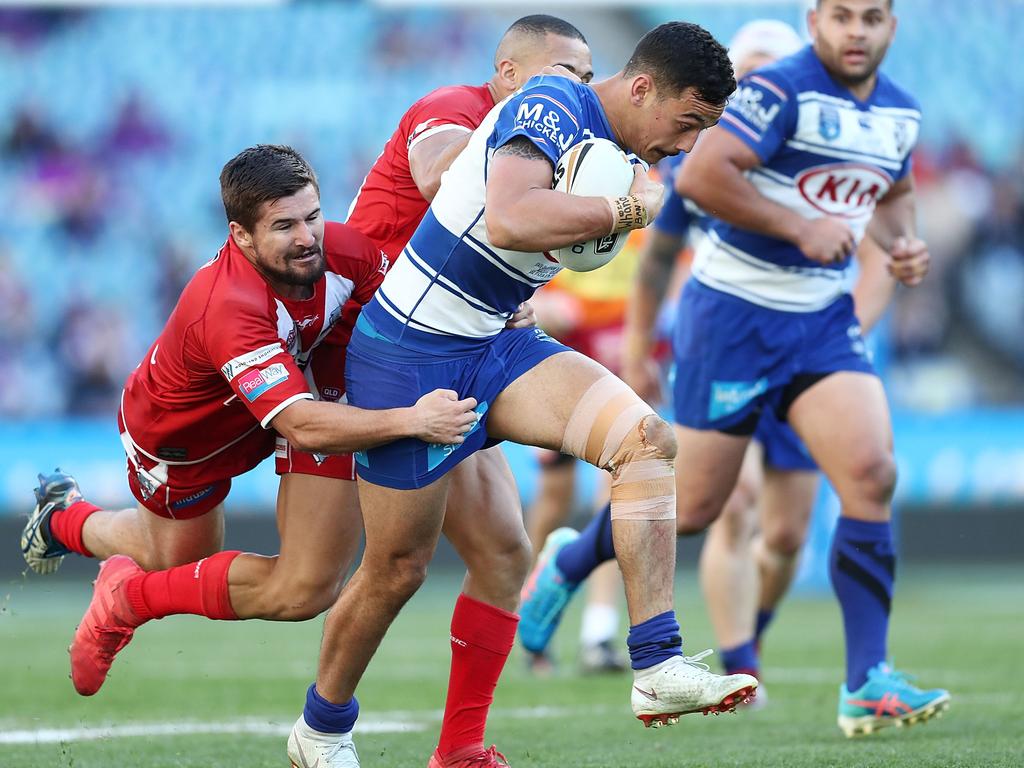 SYDNEY, AUSTRALIA - SEPTEMBER 30:  Morgan Harper of the Bulldogs is tackled during the 2018 NRL Intrust Super State Championship Grand Final match between the Canterbury-Bankstown Bulldogs and the Redcliffe Dolphins at ANZ Stadium on September 30, 2018 in Sydney, Australia.  (Photo by Mark Metcalfe/Getty Images)