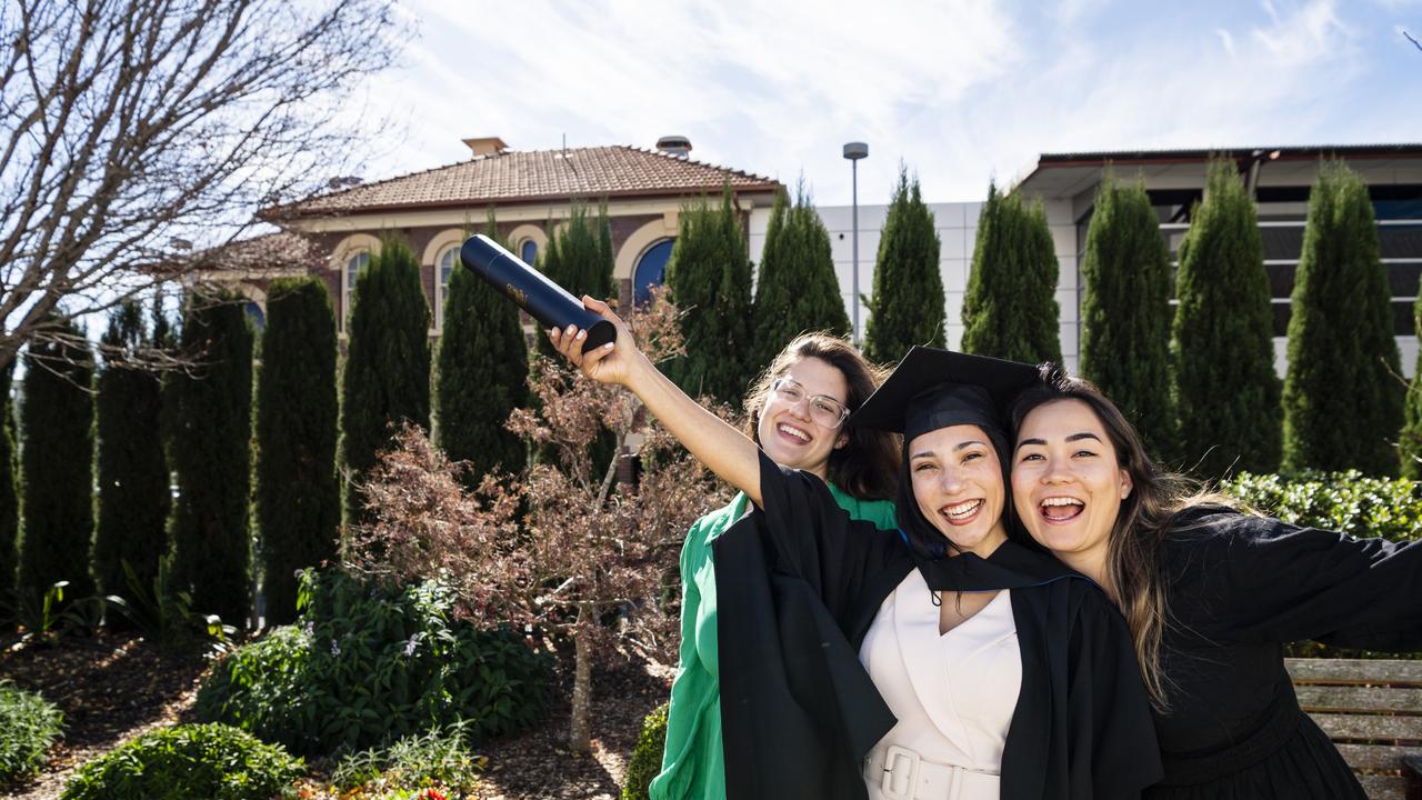 Master of Science graduate Aline dos Passos Silva with friends Luiza Sartori (left) and Marcela Reis at her UniSQ graduation ceremony at Empire Theatres, Wednesday, June 28, 2023. Picture: Kevin Farmer