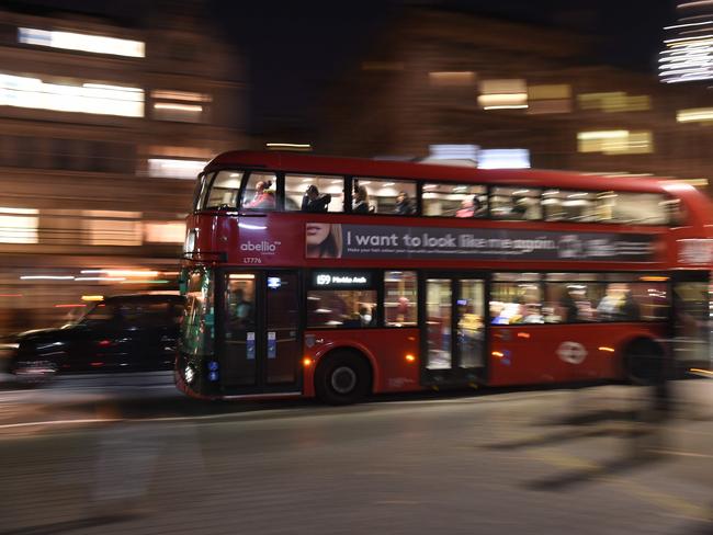 A red London bus and black taxi cab pass through central London on December 11, 2018. - Embattled British Prime Minister Theresa May faced sympathy but firm refusals on a desperate tour of European capitals on Tuesday, with EU leaders ruling out any renegotiation of the Brexit deal. A day after she postponed a crucial vote on the deal in the British parliament, May said she was meeting EU counterparts in an attempt to receive "reassurances". (Photo by Oli SCARFF / AFP)