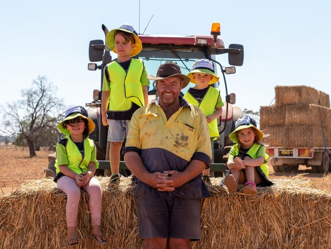 Hillview Station farmer Andrew Gartner and his children are happy to have hay delivered to their farm. Picture: Emily Ellis 