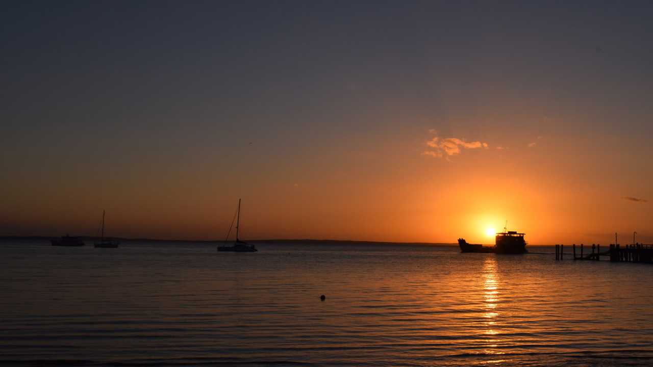 The barge leaves Kingfisher Bay as sun sets on Fraser Island. Picture: Crystal Jones