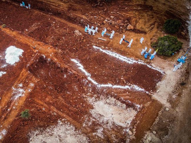 Volunteers bring the bodies of the victims of the recent Libyan flooding disaster to be buried at a mass grave. A tsunami-sized flash flood broke through two ageing river dams and destroyed entire neighbourhoods, killing 3,351 people, with thousands more missing. Picture: Ricardo Garcia Vilanova/AFP