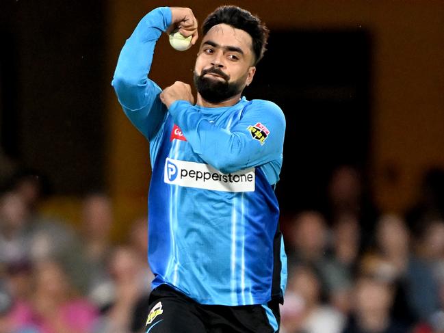 BRISBANE, AUSTRALIA - DECEMBER 23: Rashid Khan of the Strikers bowls during the Men's Big Bash League match between the Brisbane Heat and the Adelaide Strikers at The Gabba, on December 23, 2022, in Brisbane, Australia. (Photo by Bradley Kanaris/Getty Images)