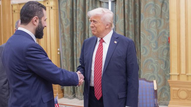 Interim Syrian President Ahmad al-Sharaa shakes hands with Donald Trump in Riyadh. Picture: AP.