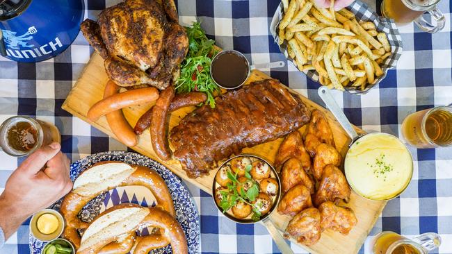 The Bavarian's "The Epic Sports Feast" includes a 2L beer tower plus pretzels, mac and cheese balls, a whole roast chicken, a rack of ribs, chicken wings, sausages, fries and mashed potato. Pictures: Supplied