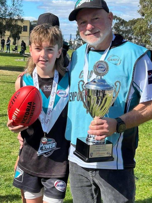 Sean Adams with son Cameron after the 2023 Under 14s premiership win with Newport Power Junior Football Club.