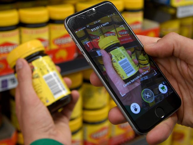 Woolworths' employee Bryn Rayfield uses the company's new Scan & Go app at the Double Bay store in Sydney, Thursday, September 6, 2018. The supermarket will offer customers the opportunity to take part in a trial of the app which allows shoppers to scan and pay for items without using a check-out. (AAP Image/Dan Himbrechts) NO ARCHIVING