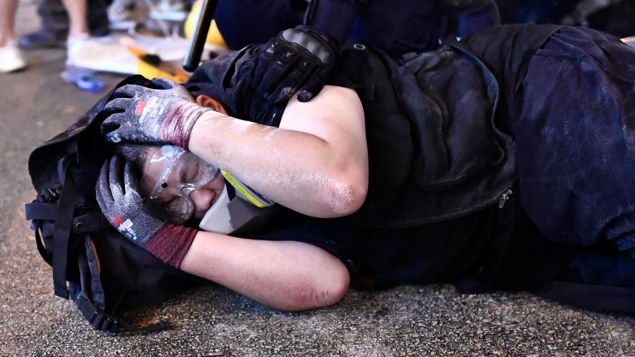 A protester is detained by police during a demonstration.