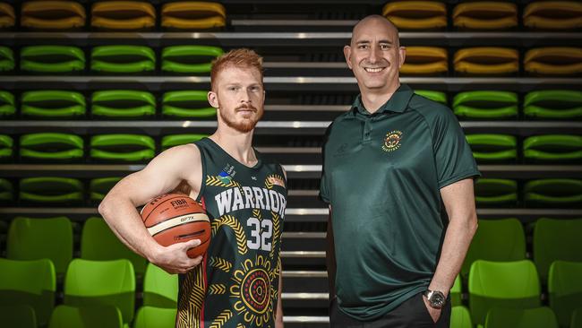 Woodville Basketball Club's James Boonstoppel, pictured wearing the specially designed indigenous jersey, alongside Warriors coach Scott Whitmore. Picture: AAP/Roy VanDerVegt