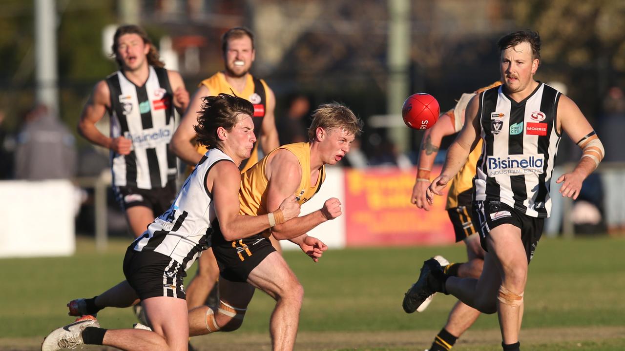 Bannockburn's Austin Mahoney handballs under pressure from North Geelong's Cooper Vaughan. GDFNL North Geelong v Bannockburn. Picture: Alan Barber
