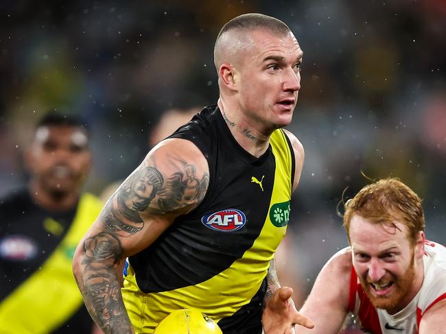 MELBOURNE, AUSTRALIA - JULY 06: Dustin Martin of the Tigers fends off Aaron Francis of the Swans during the 2023 AFL Round 17 match between the Richmond Tigers and the Sydney Swans at the Melbourne Cricket Ground on July 6, 2023 in Melbourne, Australia. (Photo by Dylan Burns/AFL Photos via Getty Images)