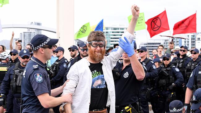 Police arrest activists from the Extinction Rebellion (XR) group after they took over the William Jolly Bridge on October 11. They will target a Toowong Creek construction site tomorrow morning. Picture: AAP Image/Dave Hunt