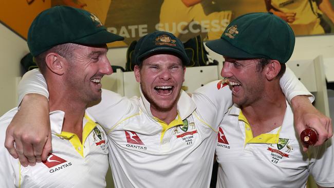 Australian players (l-r) Shaun Marsh, Steve Smith and Mitch Marsh celebrate in the WACA dressing room following their third Test win. Smith is holding the Ashes urn.