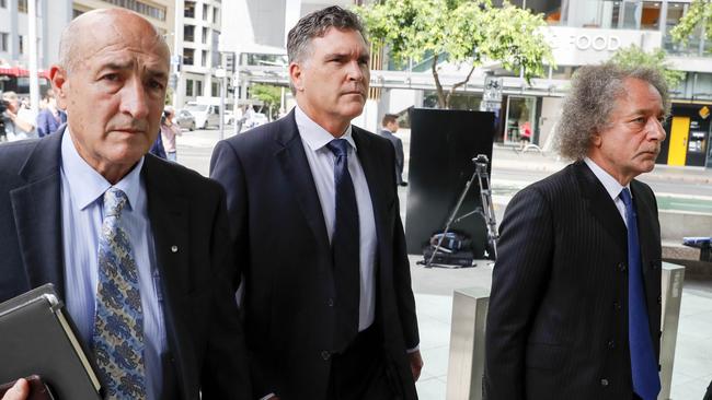 Dreamworld CEO Craig Davidson (centre) arrives with Ardent Leisure chairman Gary Weiss, right, and lawyers to the pre-inquest hearing into the fatal accident at the Dreamworld theme park. Picture: AAP Image/Glenn Hunt