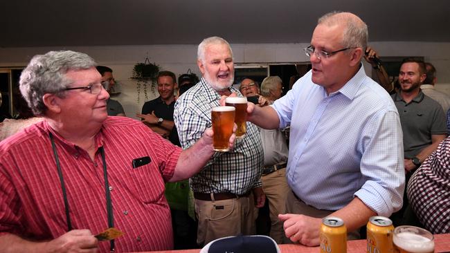 Australian Prime Minister Scott Morrison (right) and the Head of the North Queensland Livestock Industry Recovery Agency Shane Stone enjoy a beer at the Cloncurry Bowls Club in May. Picture: AAP