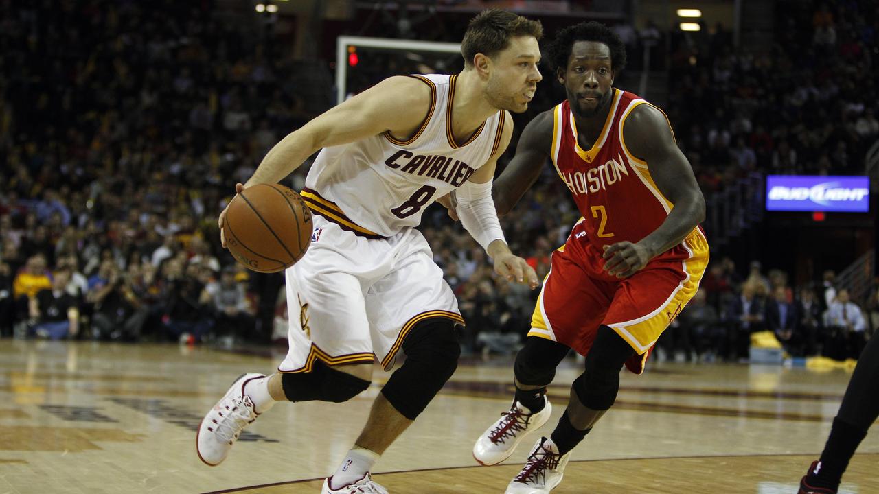 CLEVELAND, OH - JANUARY 7: Matthew Dellavedova #8 of the Cleveland Cavaliers drives to the basket against Patrick Beverley #2 of the Houston Rockets during the second half of their game on January 7, 2015 at Quicken Loans Arena in Cleveland, Ohio. The Rockets defeated the Cavaliers 105-93. NOTE TO USER: User expressly acknowledges and agrees that, by downloading and or using this photograph, User is consenting to the terms and conditions of the Getty Images License Agreement. (Photo by David Maxwell/Getty Images)