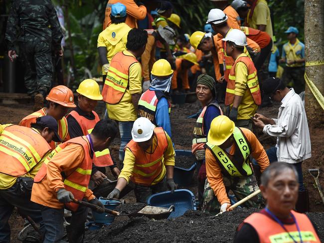 Workers fix the road leading to the cave complex. Picture: AFP