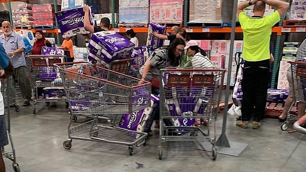 Shoppers at Costco, Casula, hurriedly purchasing 48-pack rolls of toilet paper for fear coronavirus could lead to a shortage of necessities.