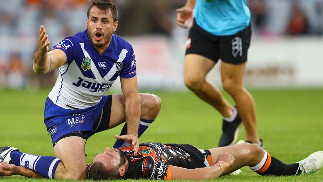 SYDNEY, AUSTRALIA - MAY 15: Josh Reynolds of the Bulldogs calls for assistance for an injured Robbie Farah of the Tigers during the round 10 NRL match between the Wests Tigers and the Canterbury Bulldogs at ANZ Stadium on May 15, 2016 in Sydney, Australia. (Photo by Mark Kolbe/Getty Images)