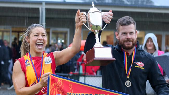 Morphettville Park captain Natalie Hadgecostas and coach Brad Ferrall lift the Adelaide Footy League women's division one premiership cup after winning the grand final on Saturday. Picture: Brayden Goldspink