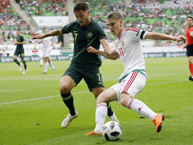 Mathew Leckie forces Hungary player Roland Sallai into the corner.