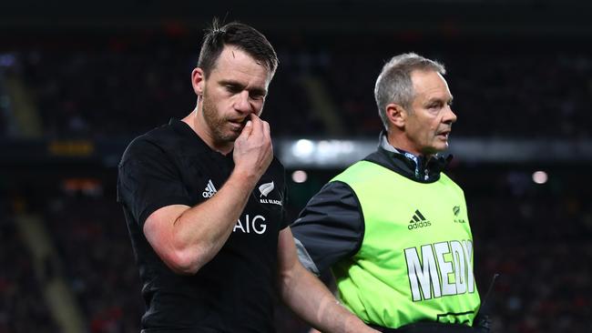 The injured Ben Smith of the All Blacks leaves the pitch at Eden Park.