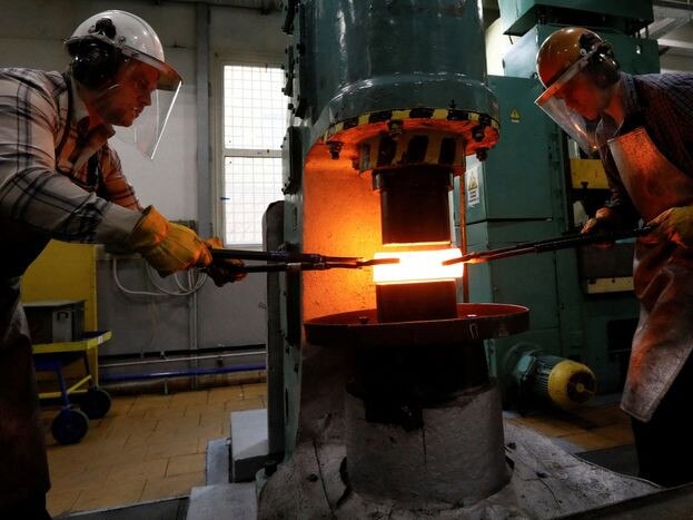 Employees at a plant of Russian palladium supplier Krastsvetmet shaped a palladium ingot in 2019. PHOTO: ILYA NAYMUSHIN/REUTERS