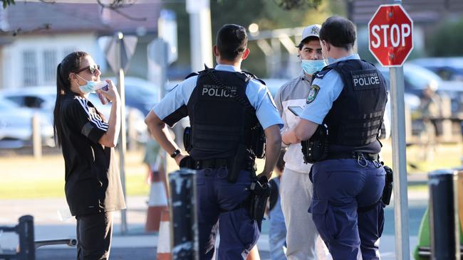 Police officers do Covid-19 compliance checks at Harold Moon reserve in Auburn.