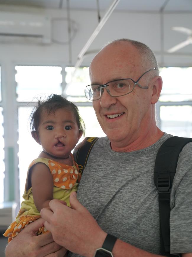 Dr Mark Moore with one of his little patients. Picture: Zameer Gill