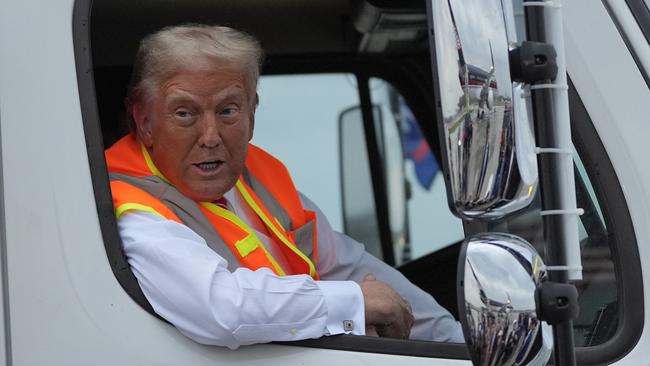 Republican presidential nominee former President Donald Trump talks to reporters as he sits in a garbage truck Wednesday, Oct. 30, 2024, in Green Bay, Wis. (AP Photo/Julia Demaree Nikhinson)