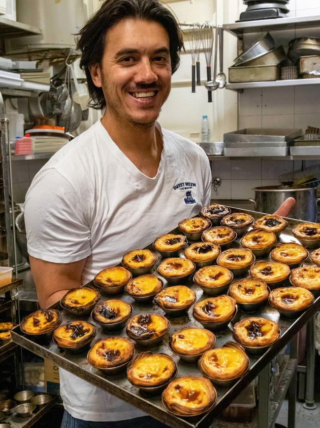 Jose Silva takes a fresh batch of Portuguese tarts out of the oven. Picture: Jenifer Jagielski