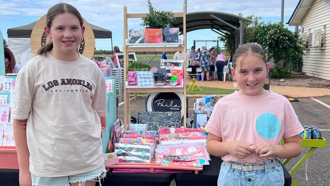 Paila Designs business owners Paisley (left) and Layla (right) selling their handmade clutches.