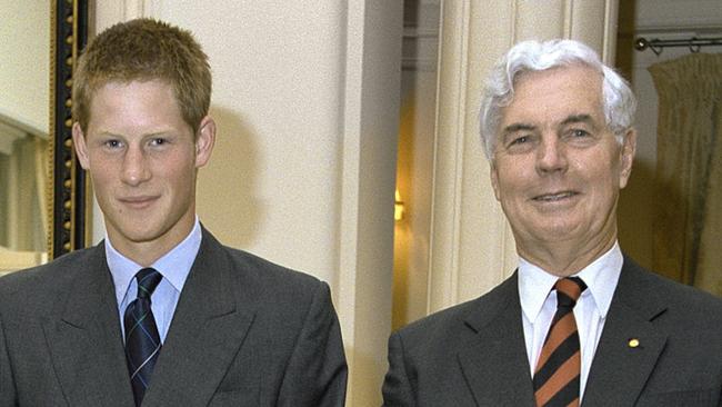 Under strict embargo until Jan 1, 2024 - as provided by the National Archives of Australia. HRH Prince Harry, flanked by Governor- General Michael Jeffery and Marlena Jeffery at Government House during his Australian ‘gap year’, Canberra, November 2003.